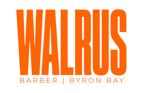 Orange text logo reading 'WALRUS' with smaller text 'BARBER | BYRON BAY' below on a white background.